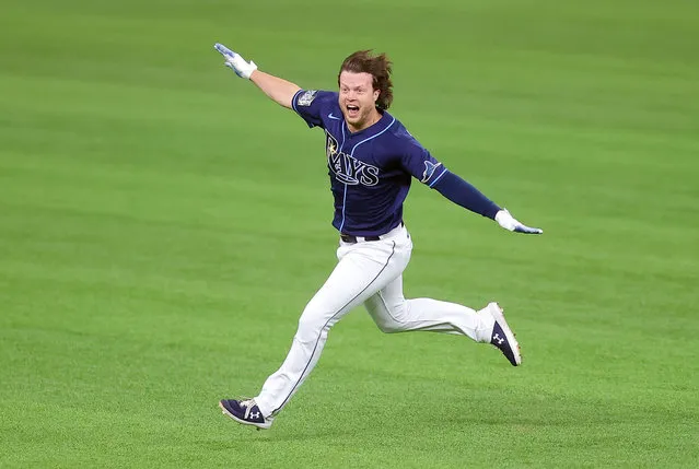 Brett Phillips #14 of the Tampa Bay Rays celebrates after hitting a ninth inning two-run walk-off single to defeat the Los Angeles Dodgers 8-7 in Game Four of the 2020 MLB World Series at Globe Life Field on October 24, 2020 in Arlington, Texas. (Photo by Ronald Martinez/Getty Images)