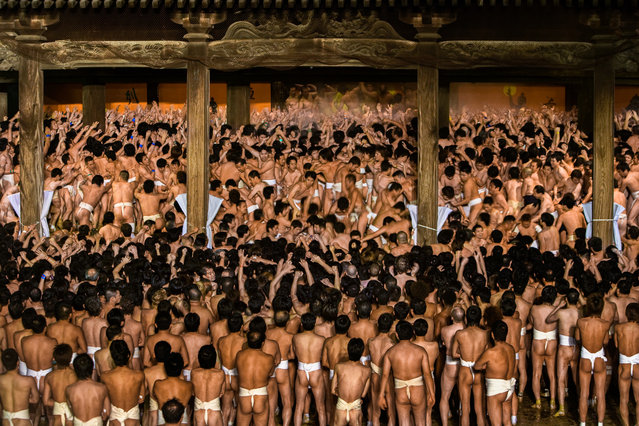 Naked Man festival in Okayama, Japan. “Held on a winter evening, the festival features 5,000 men in loincloths vying for a symbolic baton, which is tossed into the inebriated throng. Whoever possesses the baton receives good luck for the year. The scrum becomes tumultuous when one man catches the baton because anyone who touches him acquires the good luck as well”. (Photo by Art Wolfe/The Guardian)