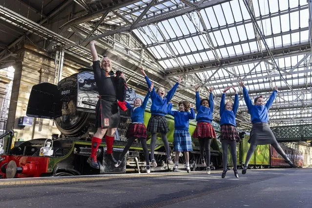 Some enthusiastic Royal Scottish Country Dance Society dancers perform “Flying Scotsman” next to the iconic locomotive as it celebrates its centenary at Waverley station in Edinburgh on Friday, February 24, 2023. (Photo by Duncan McGlynn/The Times)
