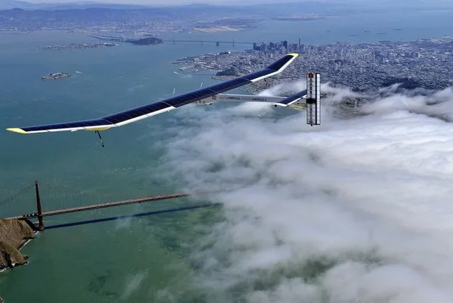 In this image provided by Solar Impulse, the sun-powered plane The Solar Impulse glides over the Golden Gate Bridge in San Francisco during a successful test flight on Tuesday, April 23, 2013. The solar-powered airplane is preparing for a journey around the world, scheduled to begin on May 1. The Solar Impulse is powered by about 12,000 photovoltaic cells that cover massive wings and charge its batteries, allowing it to fly day and night without jet fuel. It has the wing span of a commercial airplane but the weight of the average family car, making it vulnerable to bad weather. (Photo by AP Photo/Solar Impulse)