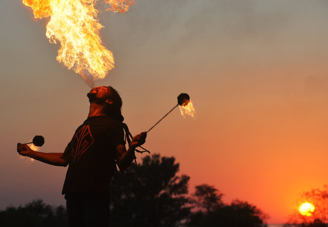 Fire dancer Nick May performs along the bluff Saturday, October 4, 2025, during “Busking Day!” held in downtown St. Joseph, Mich. (Photo by Don Campbell/The Herald-Palladium via AP Photo)