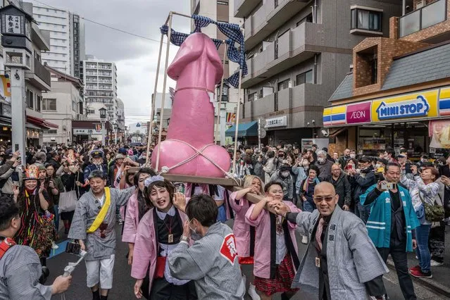 A phallic-shaped 'mikoshi' is paraded through the streets during the Kanamara festival in Kawasaki on April 2, 2023. (Photo by Yuichi Yamazaki/AFP Photo)
