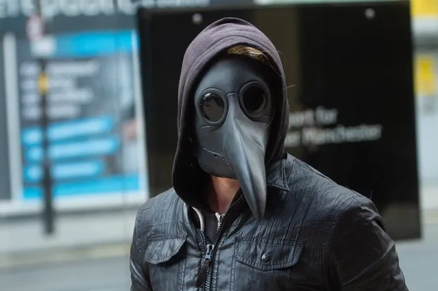 Shoppers and commuters in Manchester wearing face masks on February 28, 2020, including plague doctor masks due to the Coronavirus crisis in the UK.  (Photo by Mario Forshow/Cavendish Press)