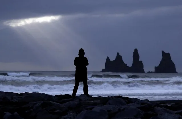 A woman stands on the black beach in Vik, Iceland, near the Volcano Katla, Friday, October 28, 2016. (Photo by Frank Augstein/AP Photo)