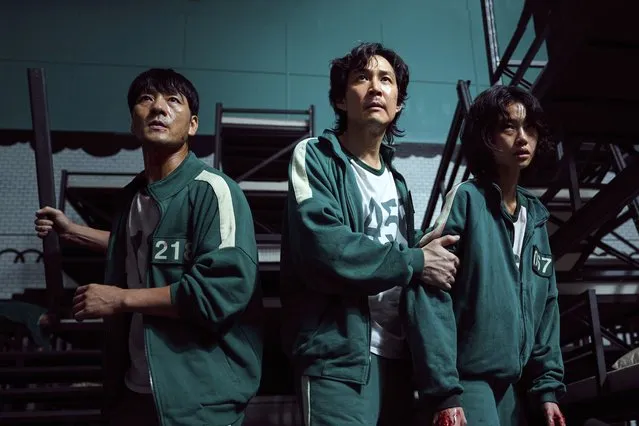 This undated photo released by Netflix shows South Korean cast members, from left, Park Hae-soo, Lee Jung-jae and Jung Ho-yeon in a scene from “Squid Game”. Squid Game, a globally popular South Korea-produced Netflix show that depicts hundreds of financially distressed characters competing in deadly children’s games for a chance to escape severe debt, has struck a raw nerve at home, where there’s growing discontent over soaring household debt, decaying job markets and worsening income inequality. (Photo by Youngkyu Park/Netflix via AP Photo)