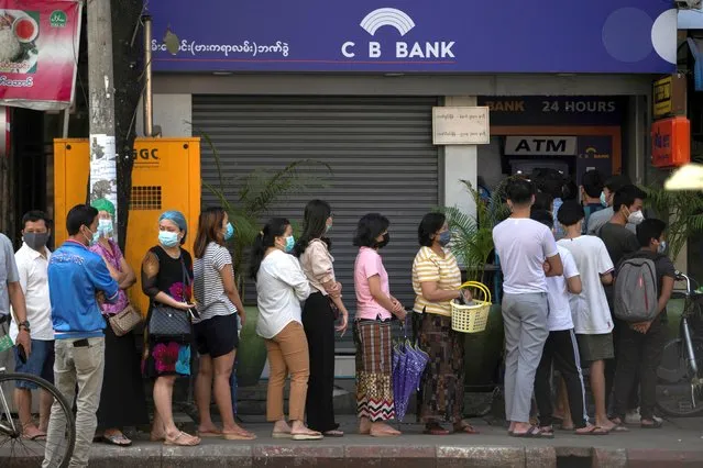 People line up outside a bank branch in Yangon, Myanmar, February 1, 2021. (Photo by Reuters/Stringer)