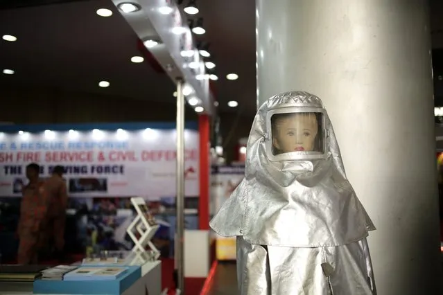 A mannequin with asbestos clothes is being displayed in a stall of the third International Trade Expo for Building and Fire Safety organized by Hong Kong-based Elevate company in Dhaka, Bangladesh, 07 December 2015. More than 36 local and international companies and organizations take part in the three-day expo to show-case equipment needed for garment factories to ensure safe work condition. (Photo by Abir Abdullah/EPA)