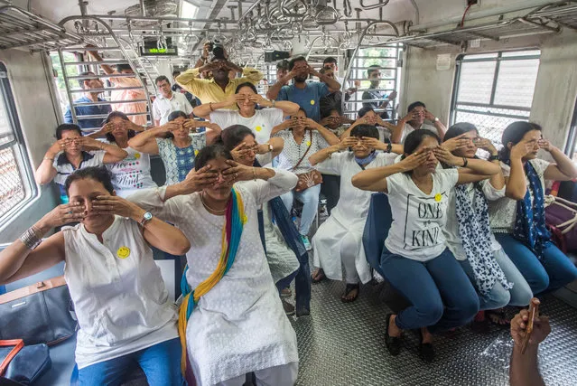 Yoga instructor along with the commuters perform yoga inside a local train on the occasion of World Yoga day, on June 21, 2018 in Mumbai, India. The first International Yoga Day was observed all over the world on June 21, 2015. The idea of International Yoga Day was first proposed by the PM during his speech at the United Nations General Assembly on September 27, 2014. He also suggested June 21 be observed as International Yoga Day all over the world, as it is the longest day of the year in the Northern Hemisphere and has special significance in many parts of the world. (Photo by Pratik Chorge/Hindustan Times via Getty Images)