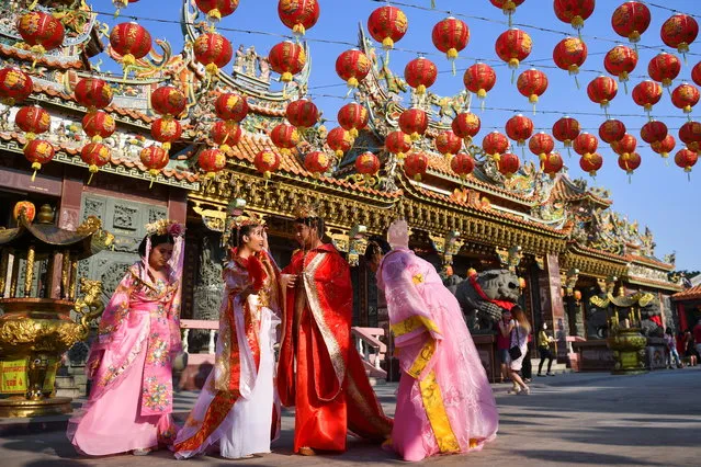 Women attend celebrations for the Lunar New Year at a Chinese temple in Samut Prakan province, Thailand, February 12, 2021. (Photo by Chalinee Thirasupa/Reuters)