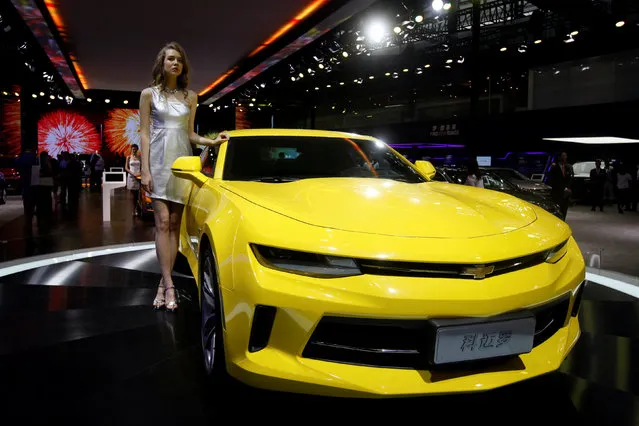 A model poses beside a Camaro by Chevrolet during China (Guangzhou) International Automobile Exhibition in Guangzhou, China November 18, 2016. (Photo by Bobby Yip/Reuters)