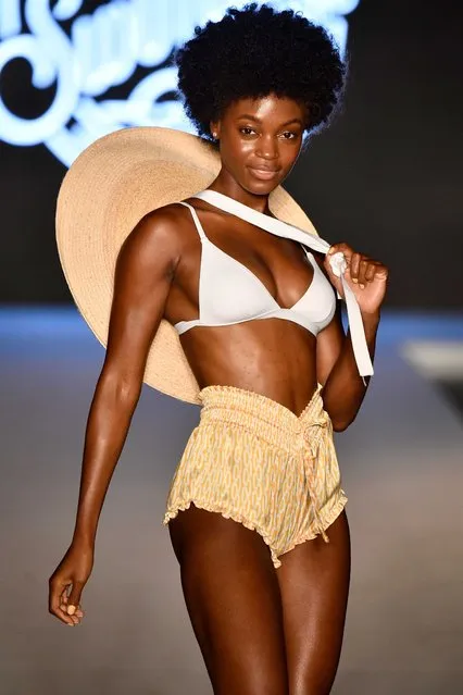 A model walks the runway in a white bikini top, shorts, and an oversize sun hat for the swimsuit show during the Paraiso Fashion Fair in Miami at the W South Beach hotel on July 15, 2018. (Photo by Alexander Tamargo/Getty Images for Sports Illustrated)