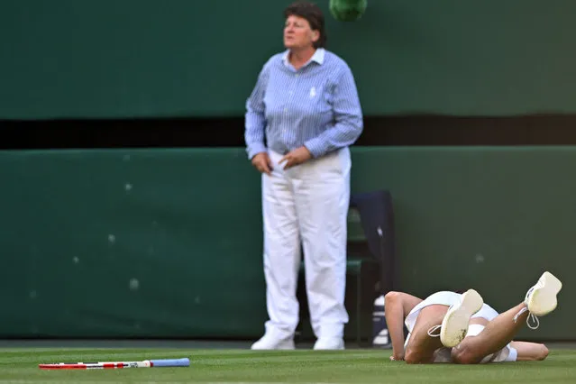 France's Alize Cornet falls down during her women's singles tennis match against Kazakhstan's Elena Rybakina on the fourth day of the 2023 Wimbledon Championships at The All England Tennis Club in Wimbledon, southwest London, on July 6, 2023. (Photo by Glyn Kirk/AFP Photo)