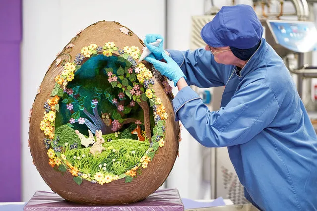 Cadbury World chocolatier Dawn Jenks adds the finishing touches to the Easter-themed chocolate creation at Cadbury World in Birmingham on Tuesday, April 12, 2022. (Photo by Jacob King/PA Images via Getty Images)