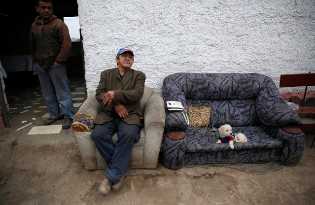 A man sits by a homeless shelter in Carabayllo in Lima, Peru July 14, 2016. (Photo by Mariana Bazo/Reuters)