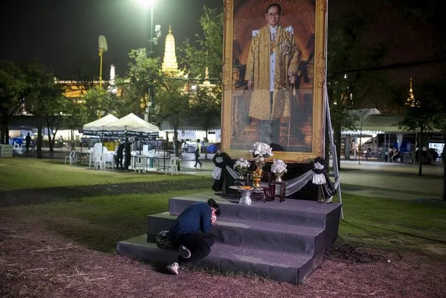 A woman kneels in front of late King Bhumibol Adulyadej's portait at the Grand Palace during a ceremony in his honor led by Thailand's Crown Prince Maha Vajiralongkorn on December 1, 2016 in Bangkok, Thailand. Thailand's Crown Prince Maha Vajiralongkorn was proclaimed Thailand's new king on Thursday, 50 days after the death of his father, King Bhumibol Adulyadej. (Photo by Borja Sanchez-Trillo/Getty Images)