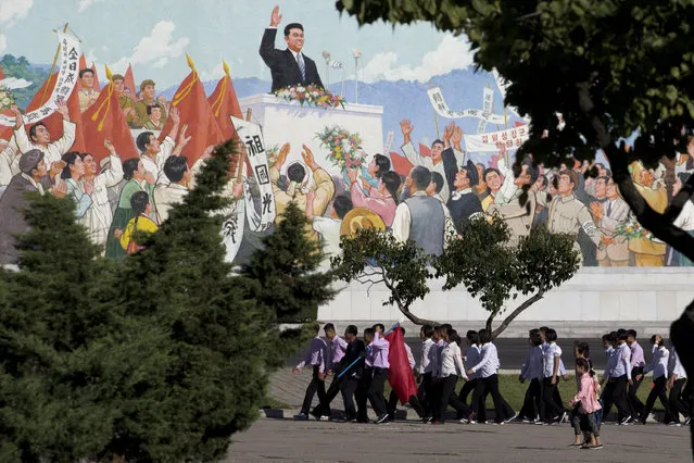 North Koreans youths march in a group past a mural as the capital prepares for the 70th anniversary of North Korea's founding day in Pyongyang, North Korea, Friday, September 7, 2018. (Photo by Ng Han Guan/AP Photo)