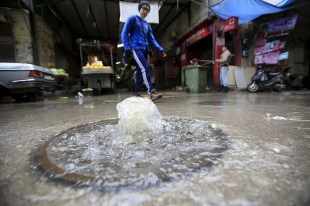 A man walks near an overflowing water drain in Ain al-Hilweh Palestinian refugee camp, near the port-city of Sidon, southern Lebanon January 19, 2016. (Photo by Ali Hashisho/Reuters)