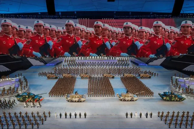 Armored vehicles roll across the stage during a show commemorating the 100th anniversary of the founding of the Communist Party of China at the National Stadium in Beijing, China on June 28, 2021. (Photo by Thomas Peter/Reuters)