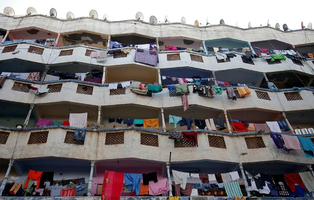 Laundry hangs from balconies of an apartment building in Ahmedabad, India, November 19, 2018. (Photo by Amit Dave/Reuters)