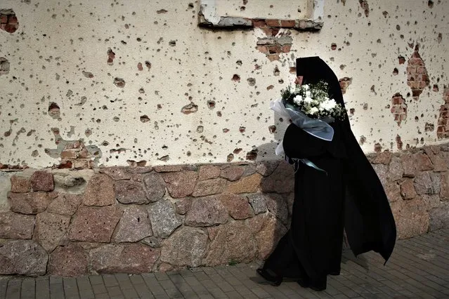 Abbess Michael walks to attend Orthodox Easter service at the Iversky Monastery a monastery of the Ukrainian Orthodox Church (Moscow Patriarchate) damaged by shelling, outside Donetsk, Ukraine, Tuesday, May 4, 2021. (Photo by Alexei Alexandrov/AP Photo)