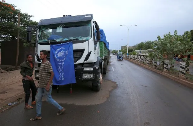 The World Food Program (WFP) convoy trucks carrying food items for the victims of Tigray war are seen parked after the checkpoints leading to Tigray Region were closed, in Mai Tsebri town, Ethiopia on June 26, 2021. (Photo by Reuters/Stringer)