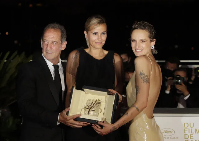Director Julia Ducournau, center, winner of the Palme d'Or for the film “Titane” poses with Vincent Lindon, left, and Agathe Rousselle during a photo call following the awards ceremony at the 74th international film festival, Cannes, southern France, Saturday, July 17, 2021. (Photo by Vianney Le Caer/Invision/AP Photo)