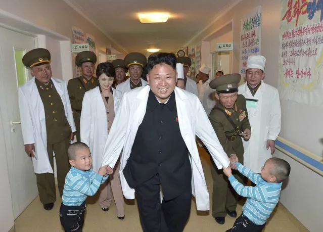 North Korean leader Kim Jong Un plays with children during a visit to the Taesongsan General Hospital in Pyongyang May 19, 2014. (Photo by Reuters/KCNA)