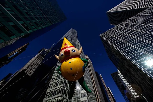 An elf balloon floats down Sixth Avenue. (Photo by Eric Thayer/Reuters)