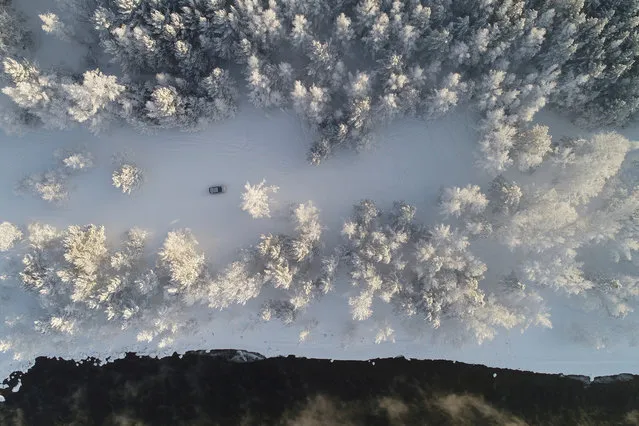 An aerial view shows a car driving along a bank of the Yenisei River, with the air temperature at about minus 30 degrees Celsius (minus 22 degrees Fahrenheit), outside Krasnoyarsk, Russia January 25, 2018. (Photo by Ilya Naymushin/Reuters)