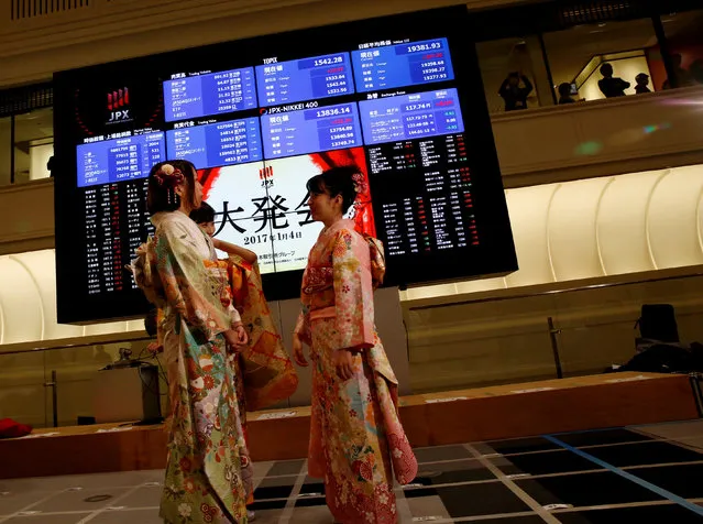 Women, dressed in ceremonial kimonos, stand in front of an electronic board showing stock prices after the New Year opening ceremony at the Tokyo Stock Exchange (TSE), held to wish for the success of Japan's stock market, in Tokyo, Japan, January 4, 2017. (Photo by Kim Kyung-Hoon/Reuters)
