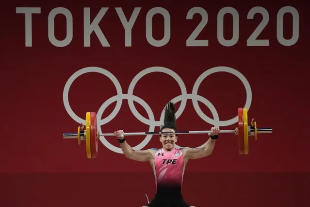 Kuo Hsing-Chun of Taiwan competes in the women's 59kg weightlifting event, at the 2020 Summer Olympics, Tuesday, July 27, 2021, in Tokyo, Japan. (Photo by Luca Bruno/AP Photo)