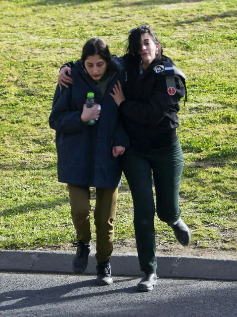 Israel female soldier is escorted from the scene of an attack in Jerusalem Sunday, January 8, 2017. (Photo by Mahmoud Illean/AP Photo)