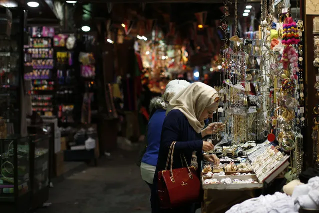 Syrian women shop at the popular Hamidiyeh old market in Damascus , Syria, Sunday, February 21, 2016. (Photo by Hassan Ammar/AP Photo)