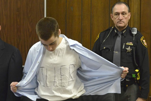 T. J. Lane takes off his shirt to show a white T-shirt with the word “Killer” spelled out on it at his sentencing hearing before Geauga County Judge David Fuhry in Cleveland, Ohio. (Photo by Duncan Scott/Reuters/The News-Herald)