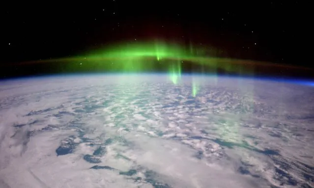 A glowing aurora photo taken by Expedition 46 flight engineer Tim Peake of the European Space Agency (ESA) from the International Space Station on February 23, 2016 is shown in this image released on February 24, 2016. Aurora are one effect of such energetic particles, which can speed out from the sun both in a steady stream called the solar wind and due to giant eruptions known as coronal mass ejections or CMEs. (Photo by Tim Peake/Reuters/ESA/NASA)