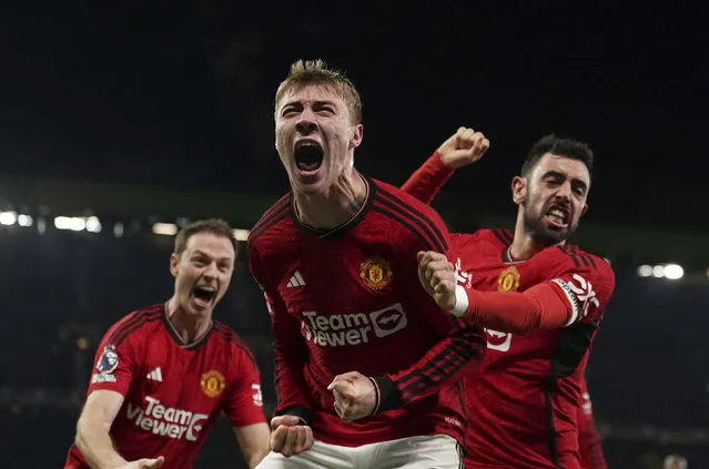 Manchester United's Rasmus Hojlund, center, celebrates scoring their side's third goal during the English Premier League soccer match between Manchester United and Aston Villa at the Old Trafford stadium in Manchester, England, Tuesday, December 26, 2023. (Photo by Martin Rickett/PA Wire via AP Photo)