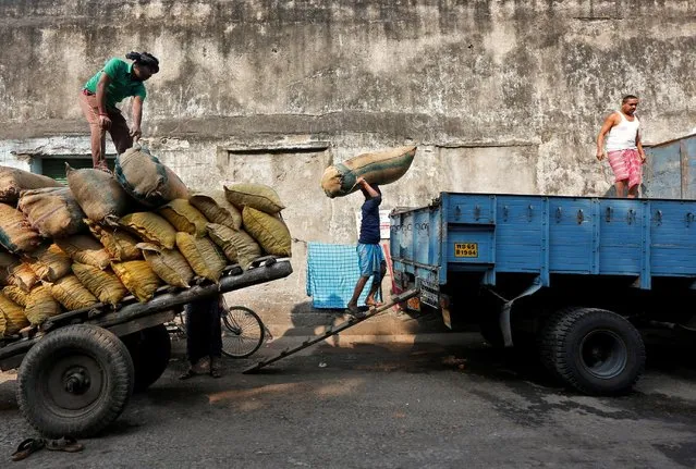 A labourer loads a sack of red chilies into a supply truck at a wholesale market in Kolkata, India January 16, 2017. (Photo by Rupak De Chowdhuri/Reuters)