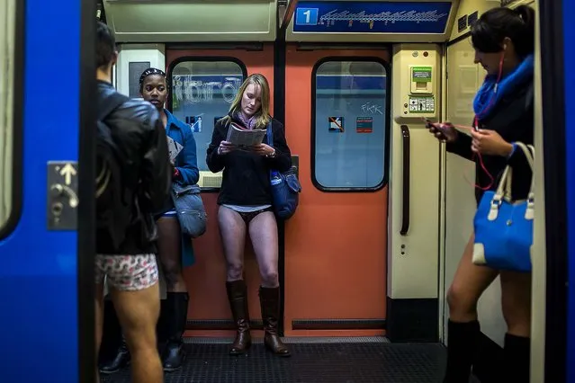 Participants travel on the train without their pants during the 5th annual No Pants Subway Ride in Madrid. (Photo by Andres Kudacki/Associated Press)