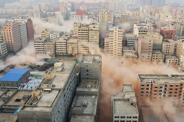 Smokes rising as buildings crumble during controlled demolition of an urban village in Zhengzhou, Henan province, China, January 23, 2017. (Photo by Reuters/Stringer)