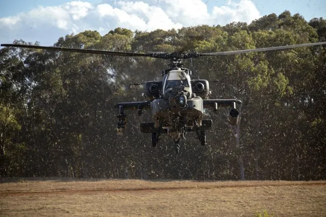 In this photo released by the U.S. Army, U.S. Army aircraft assigned to the 25th Combat Aviation Brigade, 25th Infantry Division, fly into Kahuku Training Area, Hawaii, November 2, 2023, during JPMRC. In this photo released by the U.S. Army, gunners assigned to 1163 Battery, 16th Field Regiment, Royal Regiment of New Zealand Artillery, provide comprehensive fires support to 3rd Infantry Brigade Combat Team, 25th Infantry Division, on Area X-Ray, Schofield Barracks, Hawaii, Nov. 2, 2023. In the largest-scale training held in Hawaii so far, more than 5,000 troops from the 25th Infantry Division, along with units from New Zealand, Indonesia, Thailand and Britain and supported by the U.S. Air Force, have been practicing fighting in an island jungle environment against an advanced enemy force, with exercises including paratrooper drops, a long range air assault, and re-supply by air and sea.(Photo by Sgt. Richard Mohr/U.S. Army via AP Photo)