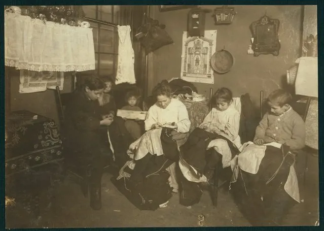The Onofrio Cottone family finish garments in a tenement in New York, January 1913, in this Library of Congress handout photo. The three oldest children Joseph, 14, Andrew, 10, and Rosie, 7, help their mother sew garments and together they make about $2 a week when work is plenty. (Photo by Reuters/Bain Collection/Library of Congress)