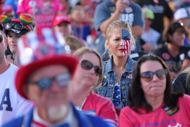 A supporter is seen with half her face painted in the colors of the U.S. flag during a rally attended by former U.S. President Donald Trump in Perry, Georgia, U.S. September 25, 2021. The former president expressed support for Herschel Walker, a controversial former NFL running back hoping to challenge the Democratic senator Raphael Warnock in midterm elections next year. (Photo by Dustin Chambers/Reuters)