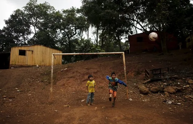 Guarani Indian boys play with a ball in the village of Pyau at Jaragua district, in Sao Paulo April 30, 2015. (Photo by Nacho Doce/Reuters)