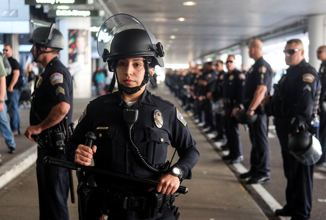 Police officers stand guard as demonstrators in support of and against the immigration rules implemented by U.S. President Donald Trump's administration, rally at Los Angeles international airport in Los Angeles, California, U.S., February 4, 2017. (Photo by Ringo Chiu/Reuters)