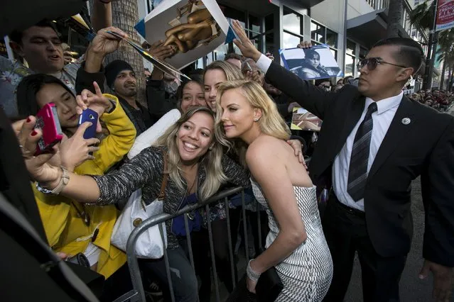 Cast member Charlize Theron poses with fans at the premiere of “Mad Max: Fury Road” in Hollywood, California May 7, 2015. (Photo by Mario Anzuoni/Reuters)