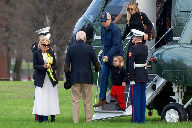 With first lady Jill Biden at left holding yellow flowers, President Joe Biden turns toward his son Hunter Biden, grandson Beau Biden and Hunter’s wife, Melissa Cohen, as they exit the Marine One helicopter and walk to a motorcade after landing at Fort McNair, Sunday, March 31, 2024, in Washington, upon return from Camp David. (Photo by Jacquelyn Martin/AP Photo)