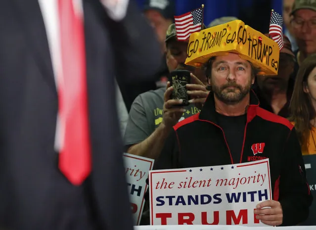 A supporter listens to U.S. Republican presidential candidate Donald Trump while he speaks during a town hall event at the La Crosse Center in La Crosse, Wisconsin April 4, 2016. (Photo by Kamil Krzaczynski/Reuters)