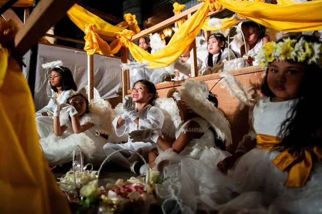 Children dressed as angels sit before the traditional procession where the images of Jesus Christ and Mary meet, on Easter Sunday, at the St. Peter Parish Shrine of Leaders in Quezon City, Metro Manila, Philippines, on March 31, 2024. (Photo by Lisa Marie David/Reuters)