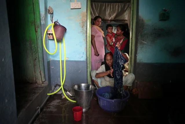 In this May 10, 2012 file photo, Fatima Munshi, working as domestic help, washes clothes at a house in Khandwa, India. Living in Australia, Saroo Brierley, 30, reunited with his biological mother, Munshi, in Feb. 2012, 25 years after an ill-fated train ride left him an orphan on the streets of Calcutta. (Photo by Saurabh Das/AP Photo)