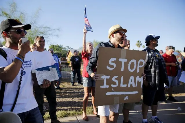 Demonstrators shout during a "Freedom of Speech Rally Round II" outside the Islamic Community Center in Phoenix, Arizona May 29, 2015. More than 200 protesters, some armed, berated Islam and its Prophet Mohammed outside an Arizona mosque on Friday in a provocative protest that was denounced by counterprotesters shouting "Go home, Nazis," weeks after an anti-Muslim event in Texas came under attack by two gunmen.    REUTERS/Nancy Wiechec